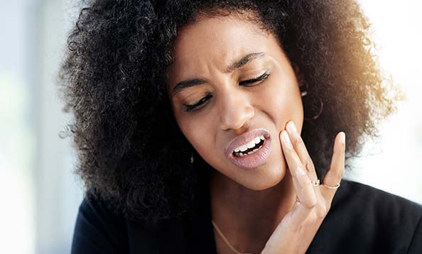 Woman suffering from tooth pain